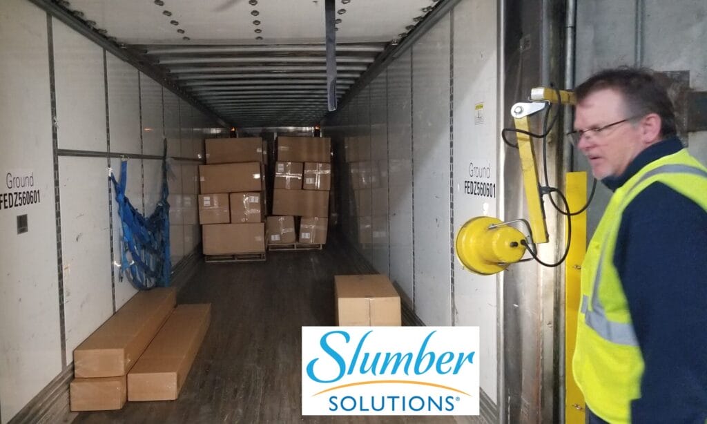 Slumber Solutions Employee in Archdale, NC loads memory foam mattress products being shipped directly to consumers within the USA.